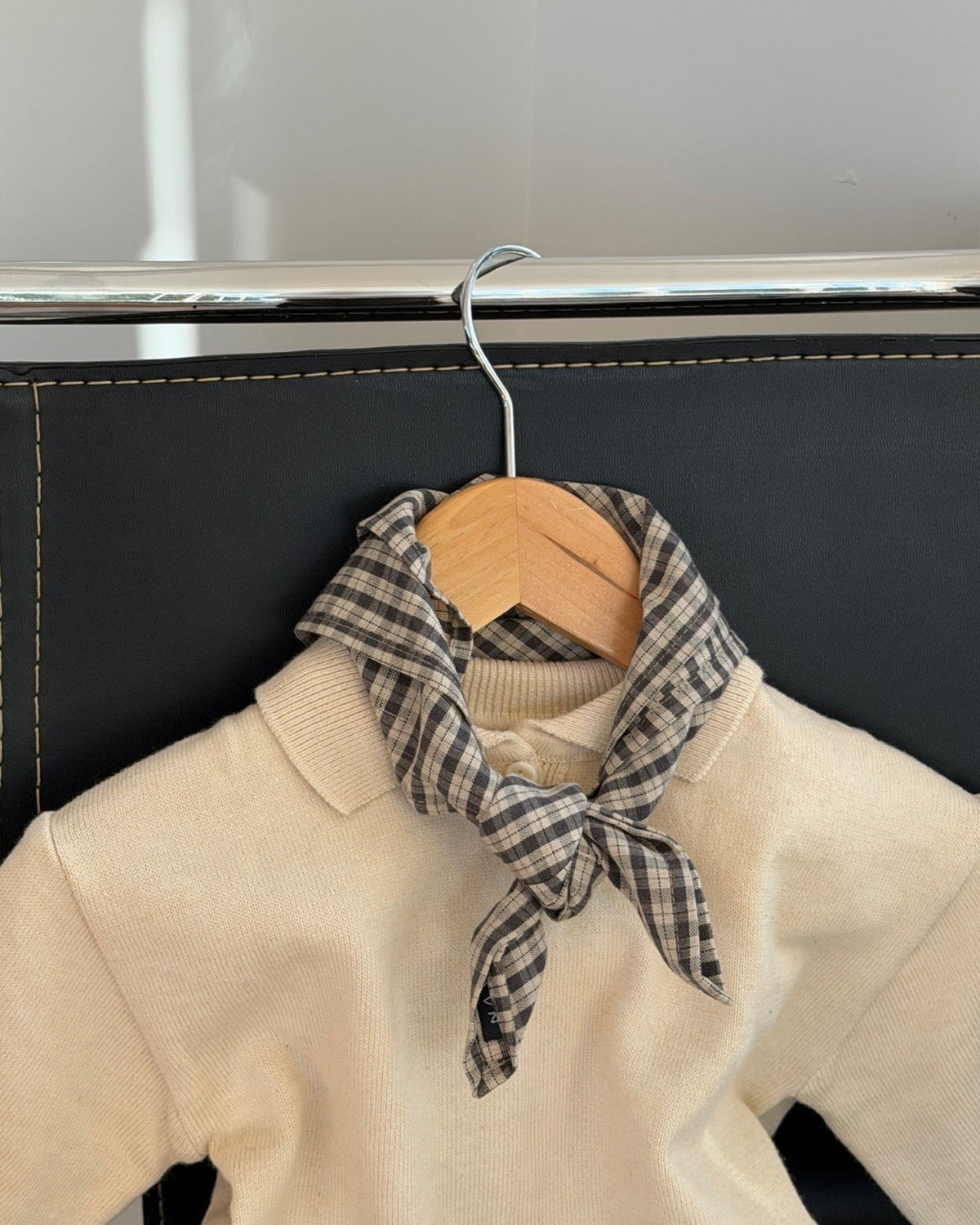 Mocca scarf in brown check cotton around a hanger with cream knit
