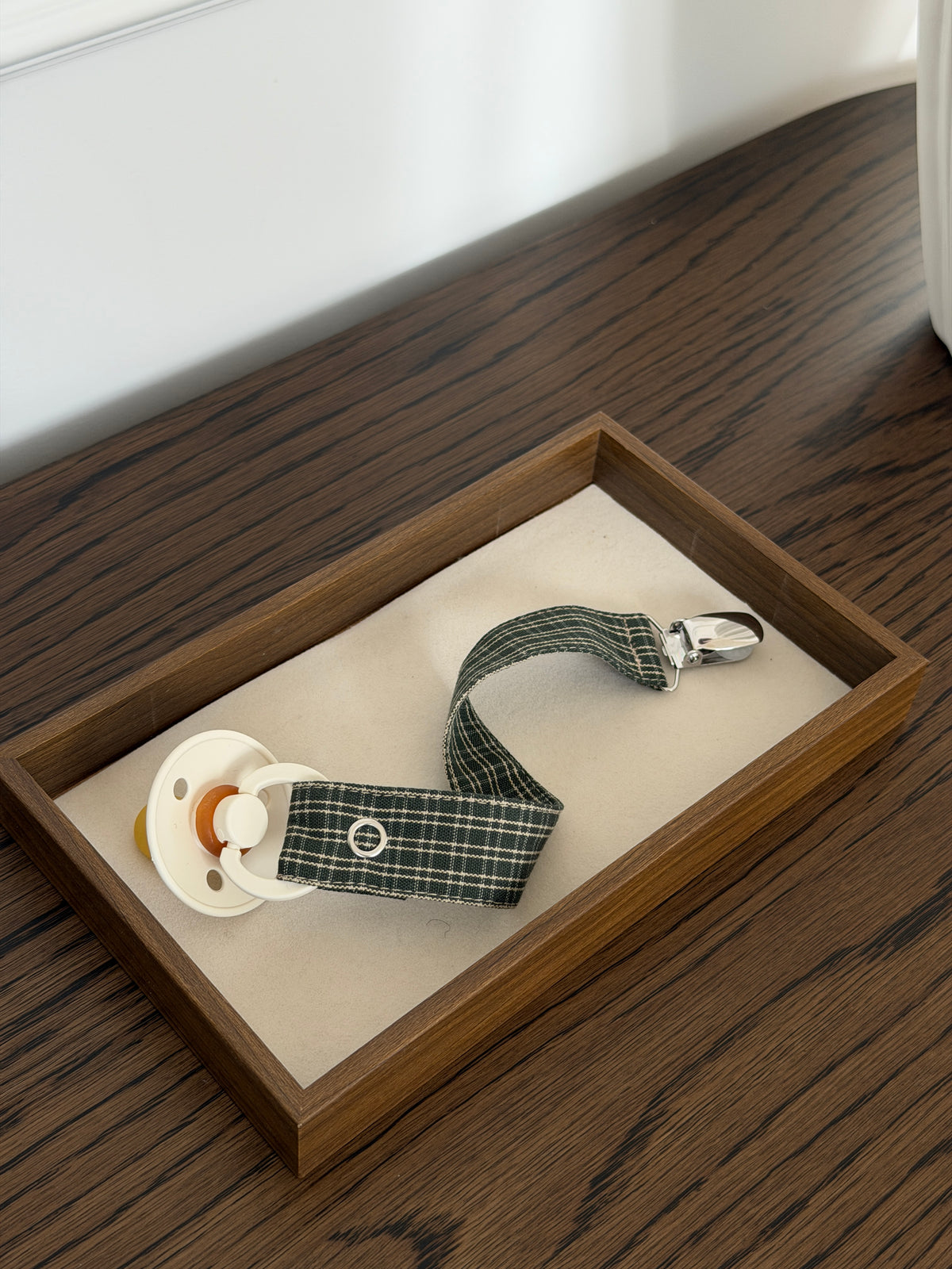 Pine dummy clip in green check with a dummy and metal clip in a wooden tray on a table