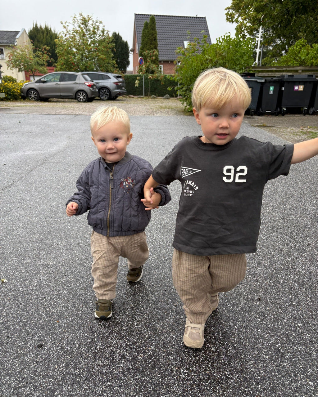 Cappuccino trousers in light beige check cotton – two boys walking along the road