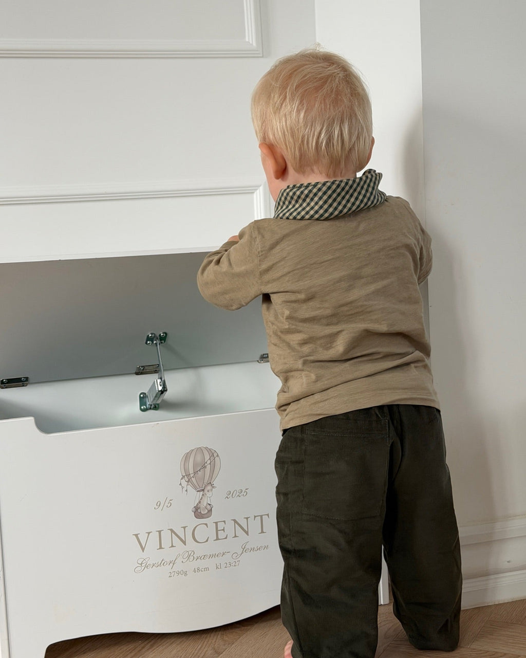 Olive trousers in olive green needlecord – boy by a toy box