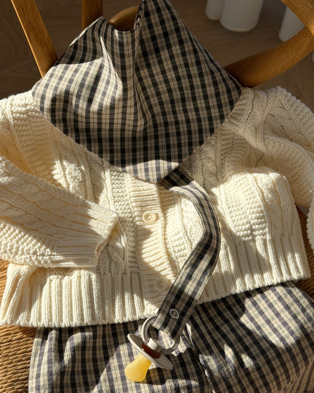 Mocca bib in brown check cotton styled with knit and trousers