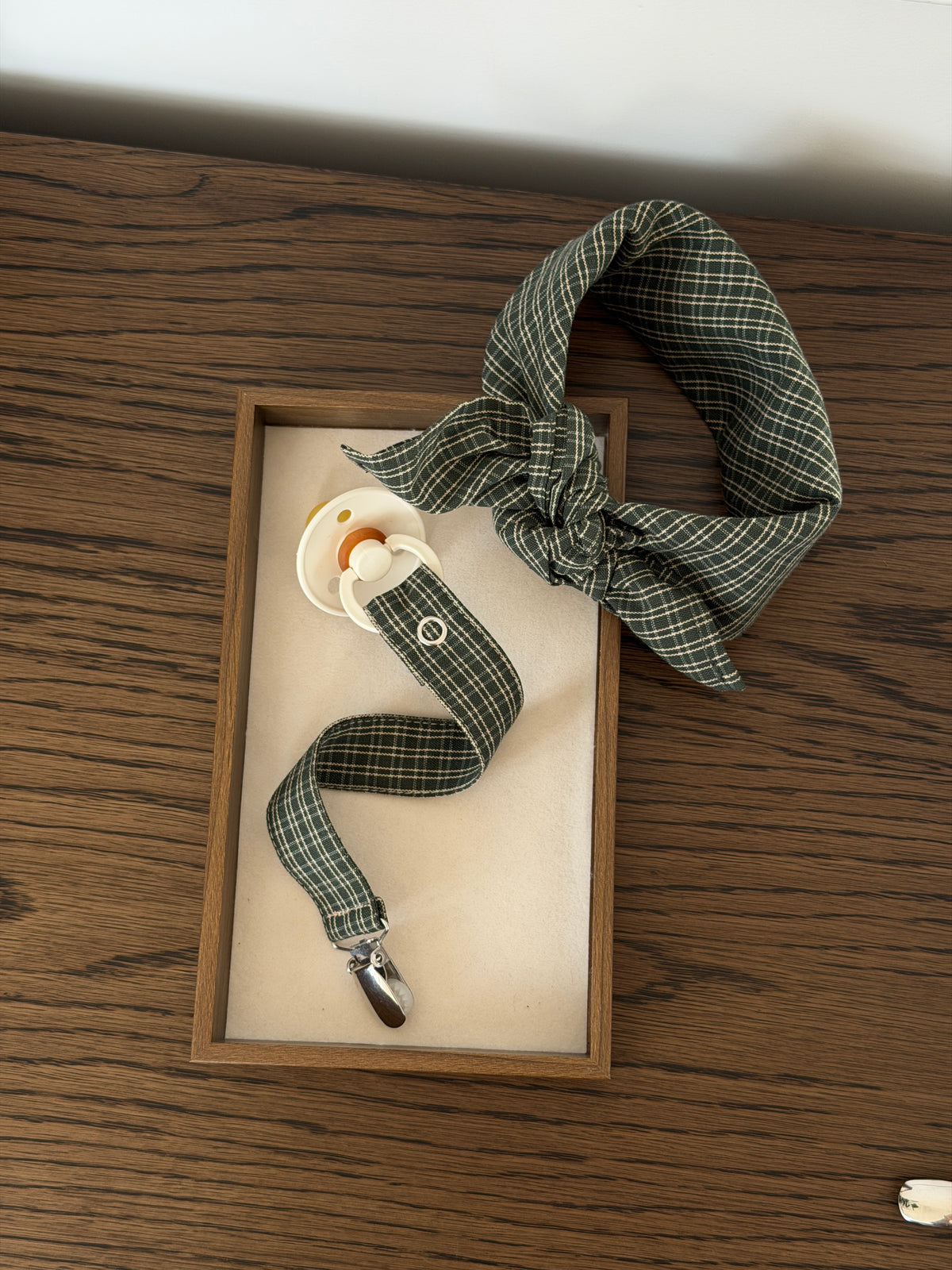Pine scarf and dummy clip in green check with a dummy in a wooden tray