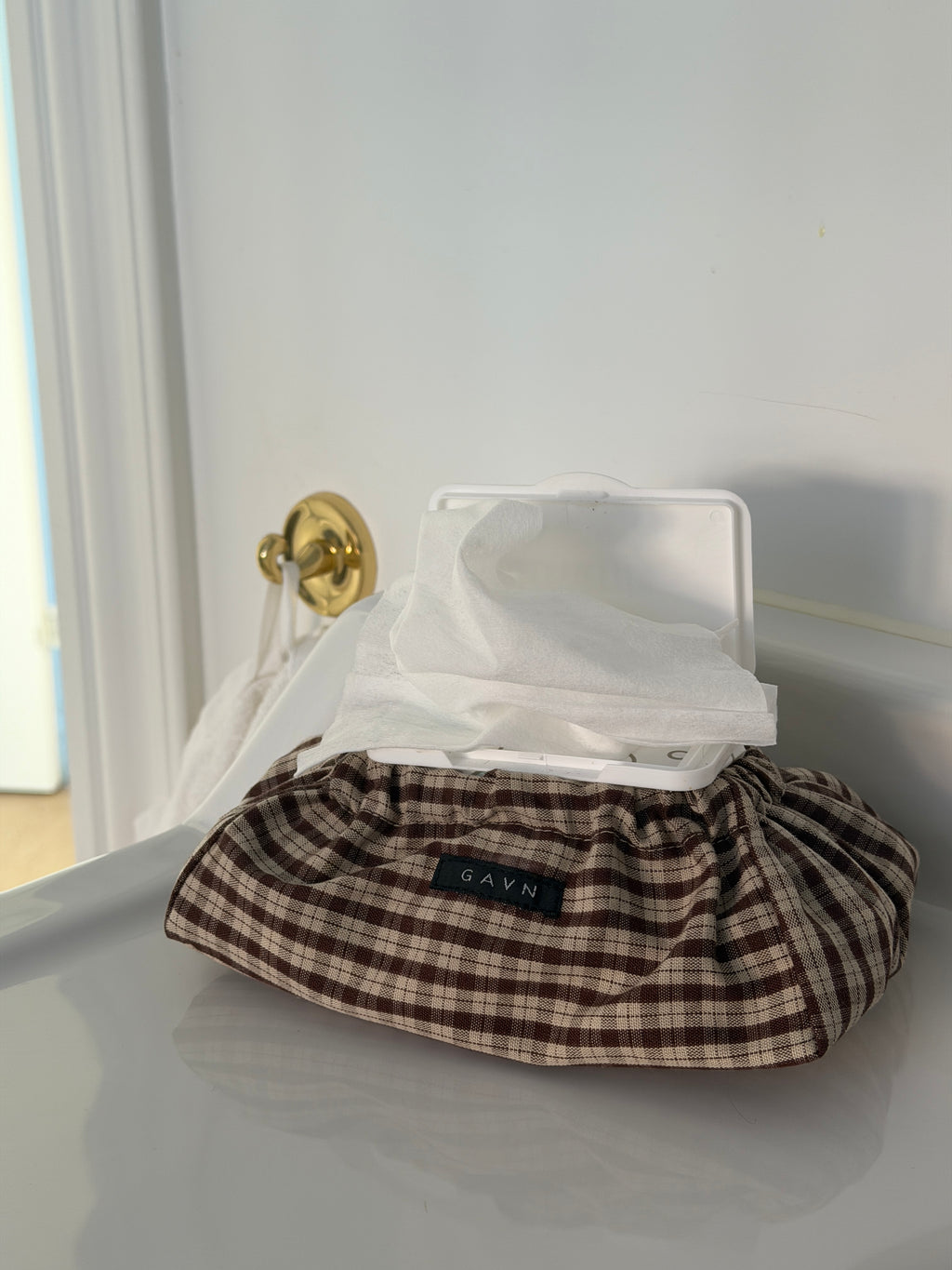 Cortado wet wipes case in brown and beige check with wet wipes in the bathroom