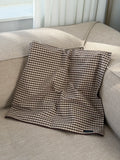 Cortado pillowcase in brown check on a light sofa